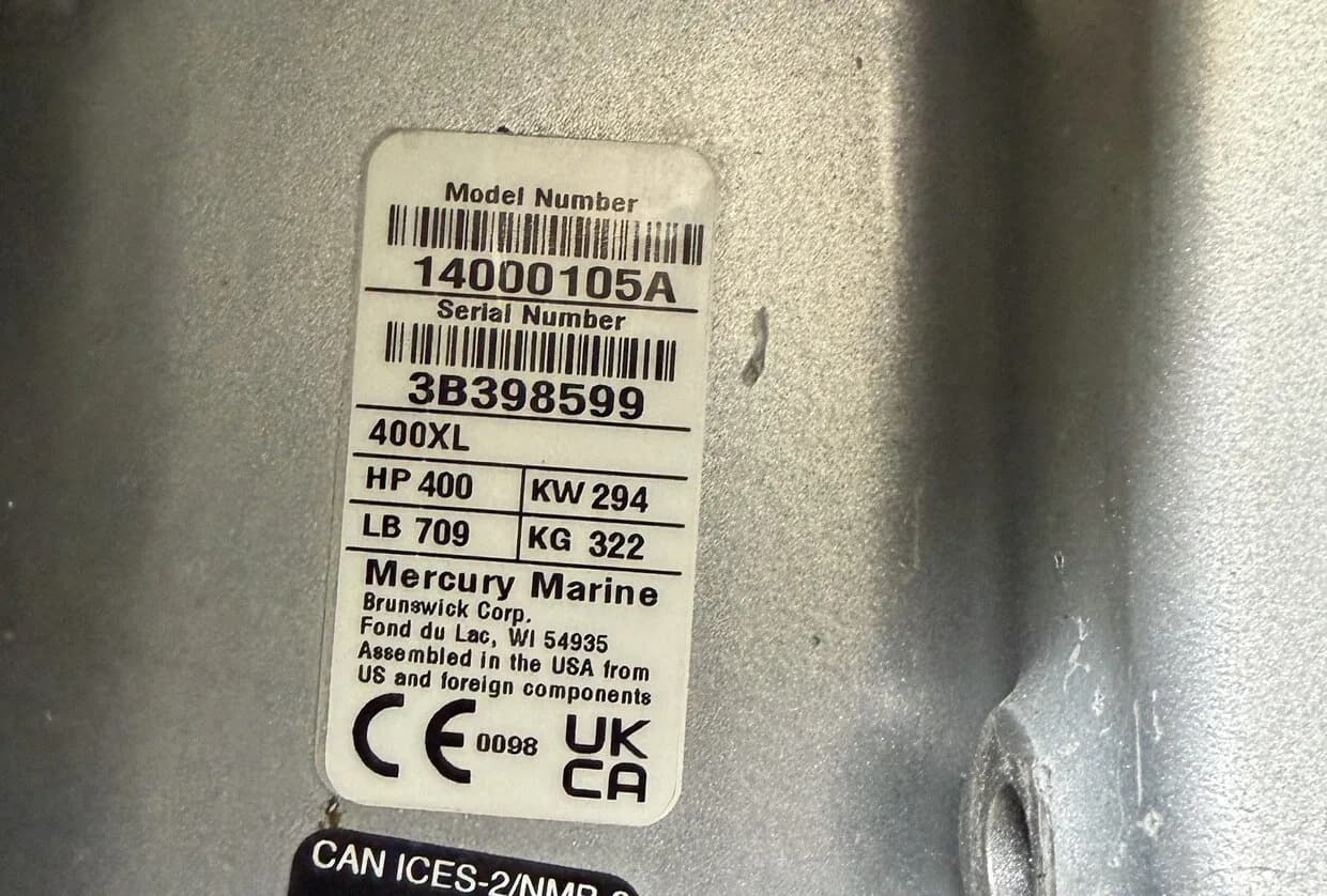 Close-up photo of an outboard motor model and serial tag