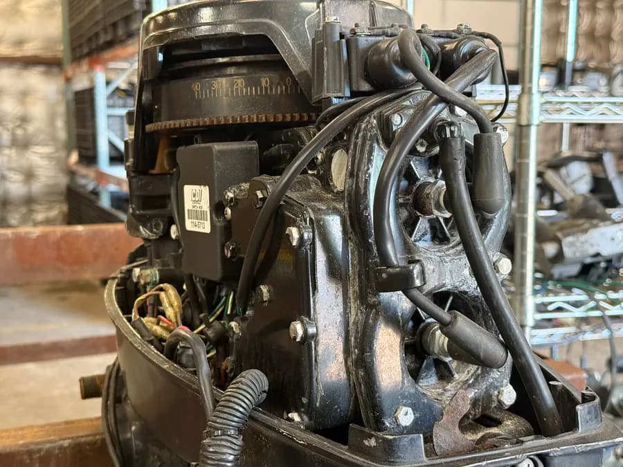 Outboard motor with wiring and mechanical components exposed