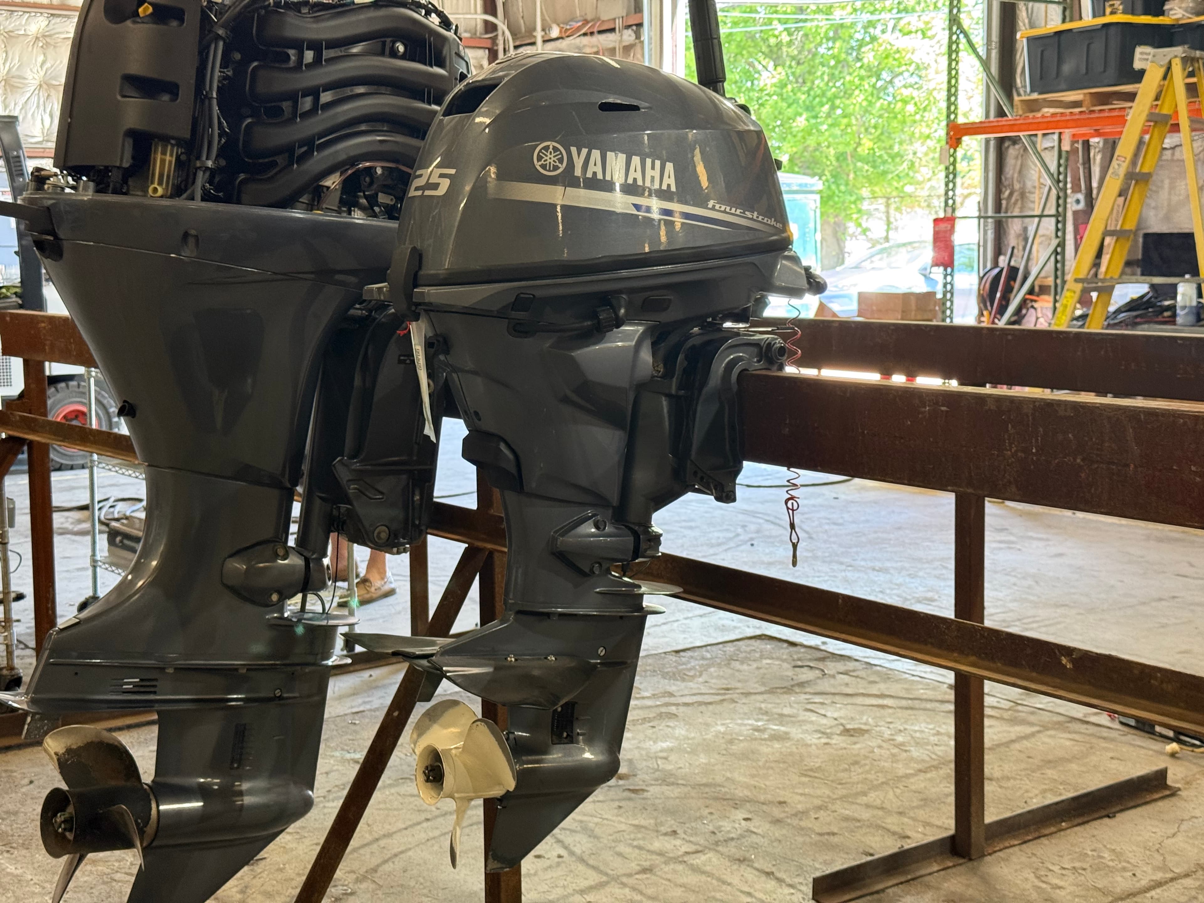 Used Yamaha outboard motors staged in the workshop