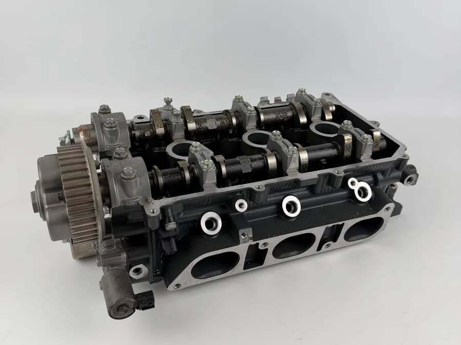 Outboard cylinder head component prepared for parts review