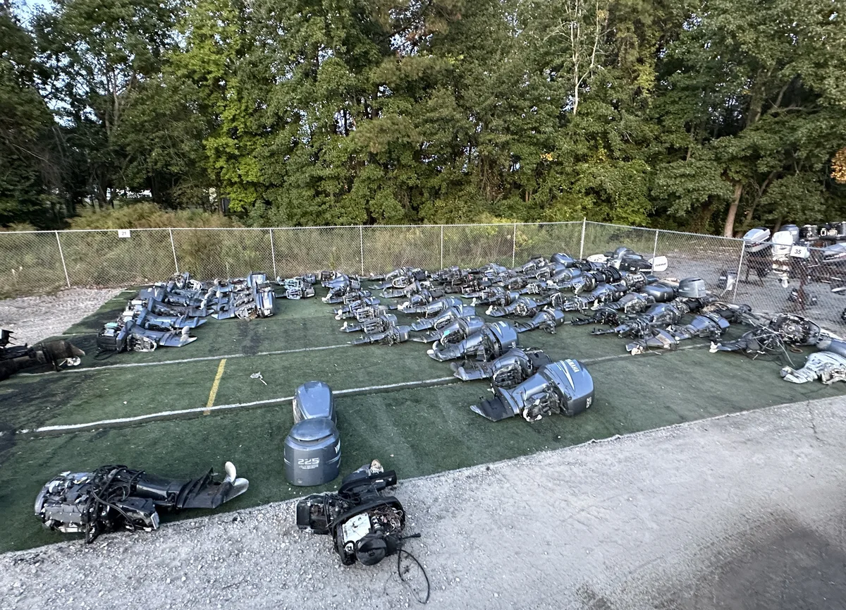 Large yard group of outboard motors in mixed condition