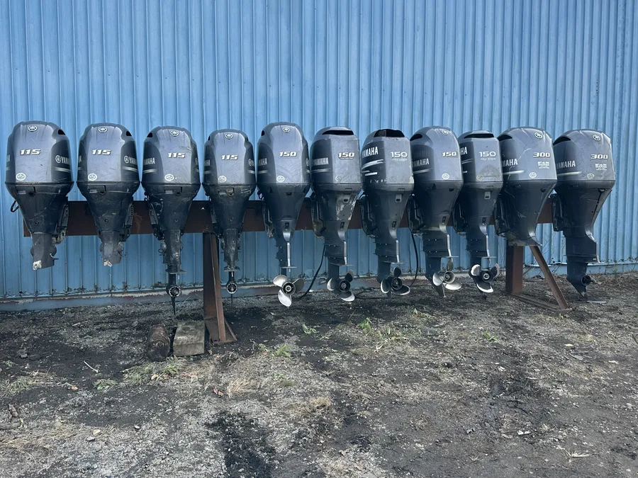 Multiple Yamaha outboard motors stored on a rack