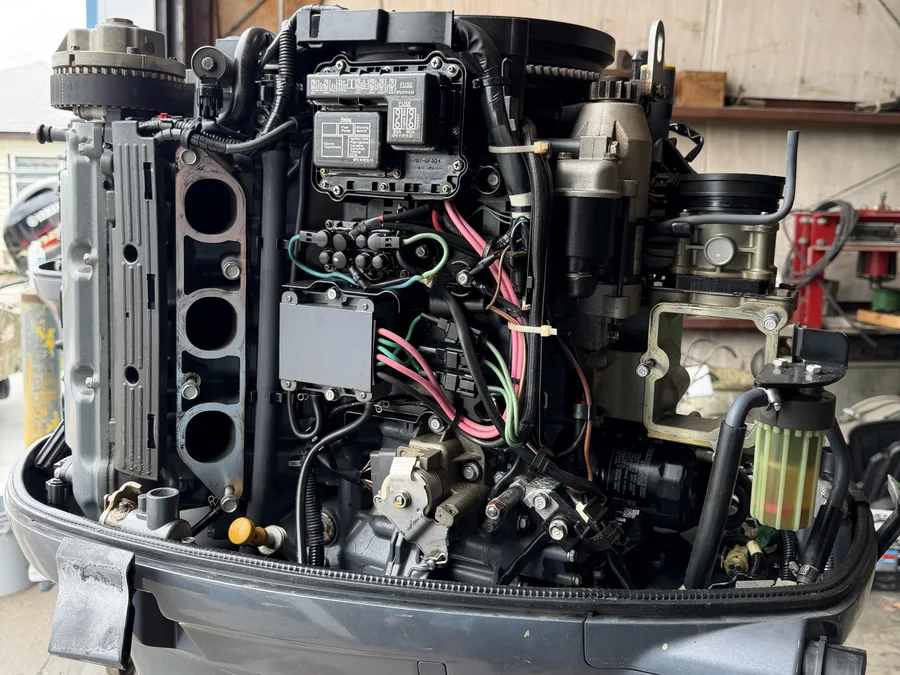 Open outboard engine showing internal parts and wiring